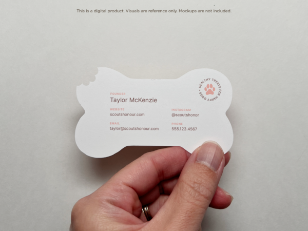 The back of a bone-shaped business card displaying essential information such as the founder's name, website, email, phone number, and Instagram handle, all in a clean and minimal layout. The card maintains the bone shape with a bite mark at the top.